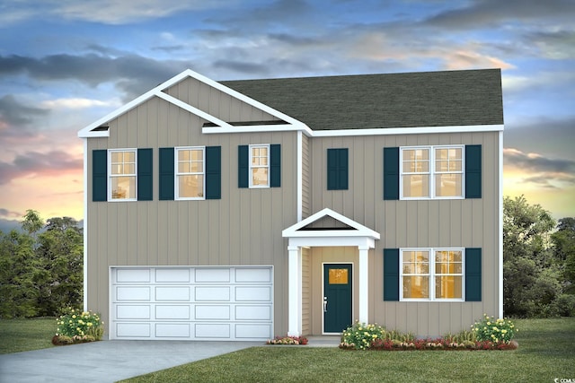 view of front of house with a garage and a yard