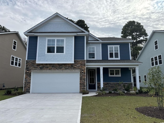 view of front of property featuring a front lawn and a garage