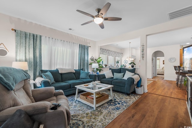 living room featuring hardwood / wood-style flooring and ceiling fan