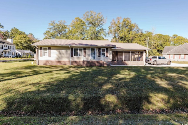 view of front of property with a front yard and a sunroom