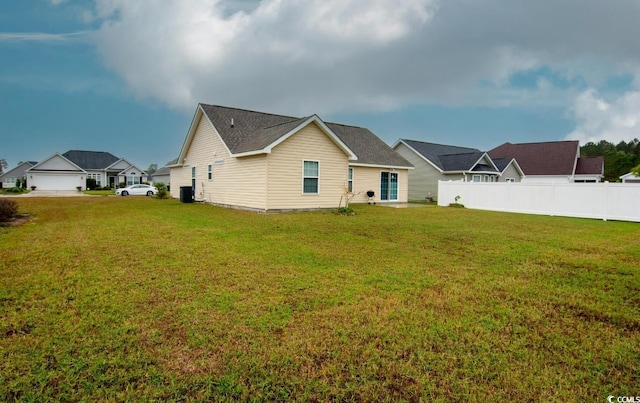 rear view of house featuring a yard