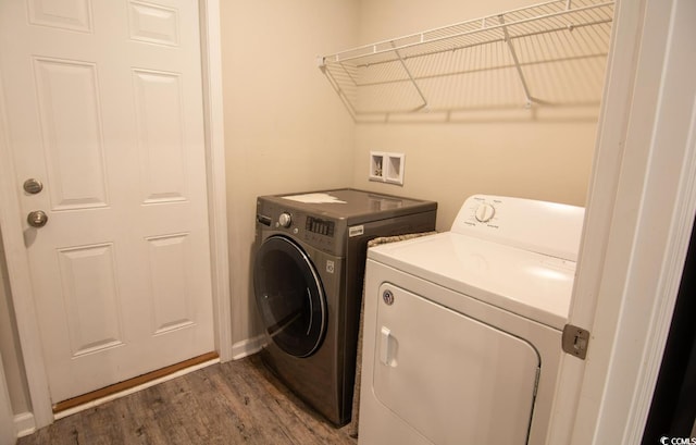 laundry room with washer and dryer and dark hardwood / wood-style floors