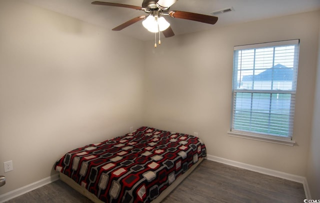 bedroom featuring ceiling fan and dark hardwood / wood-style floors