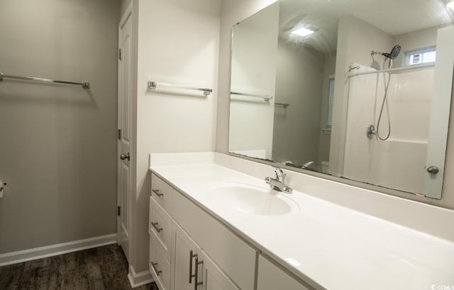 bathroom featuring hardwood / wood-style flooring, vanity, toilet, and walk in shower