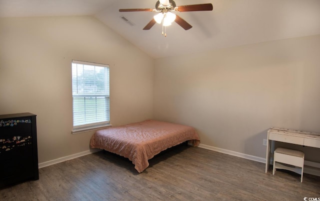 bedroom with vaulted ceiling, ceiling fan, and dark wood-type flooring