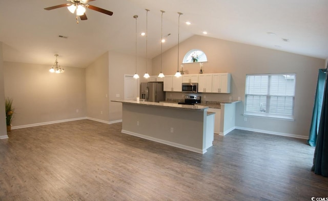 kitchen with white cabinetry, hanging light fixtures, a center island with sink, ceiling fan with notable chandelier, and appliances with stainless steel finishes