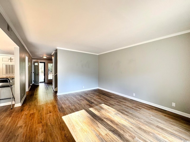 unfurnished living room with hardwood / wood-style floors and ornamental molding