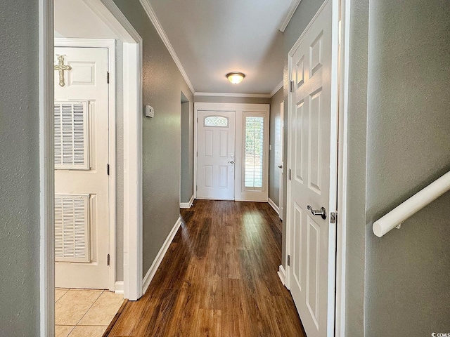 doorway with wood-type flooring and ornamental molding