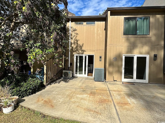 rear view of property with ac unit, a patio, and central AC unit