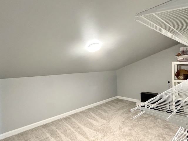 additional living space with carpet floors and lofted ceiling