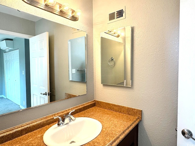 bathroom with vanity and a wall unit AC