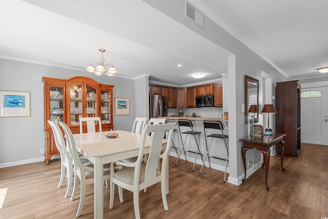 1100 Wedge Way Unit 67, Little River, SC 29566 - dining area featuring crown molding, light wood-type flooring, a chandelier, baseboards, and recessed lighting