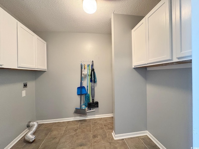 1100 Wedge Way Unit 67, Little River, SC 29566 - laundry room with hookup for an electric dryer, cabinet space, a textured ceiling, baseboards, and dark tile patterned flooring