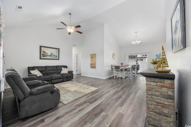 living room with ceiling fan with notable chandelier, high vaulted ceiling, and hardwood / wood-style floors