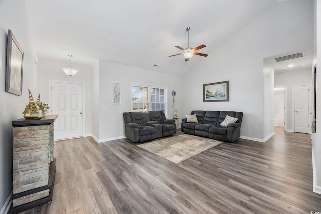 living room featuring ceiling fan, dark hardwood / wood-style flooring, and high vaulted ceiling