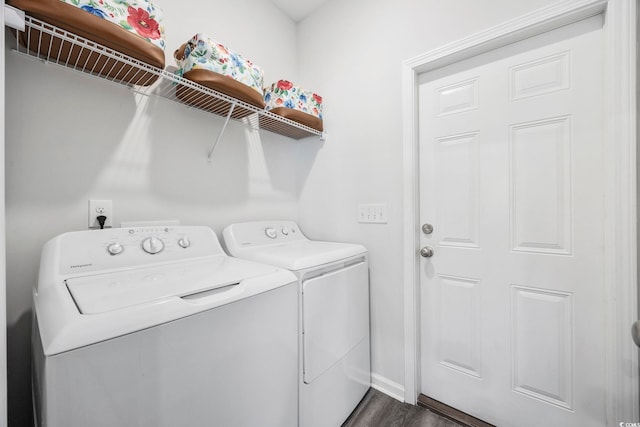 clothes washing area with washer and clothes dryer and dark hardwood / wood-style floors