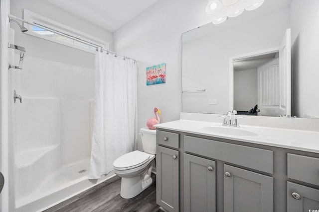 bathroom with a shower with curtain, vanity, toilet, and hardwood / wood-style floors