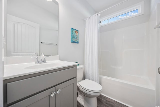 full bathroom featuring toilet, wood-type flooring, shower / bathtub combination with curtain, and vanity