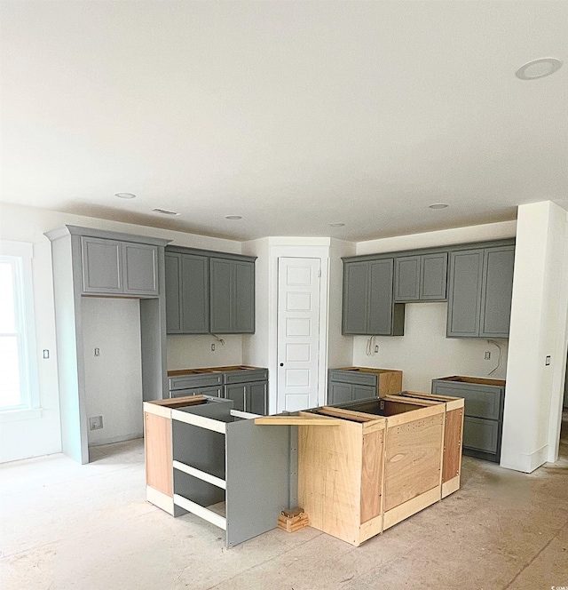 314 Hollywood Dr S, Surfside Beach, SC 29575 - kitchen with a kitchen island and gray cabinets