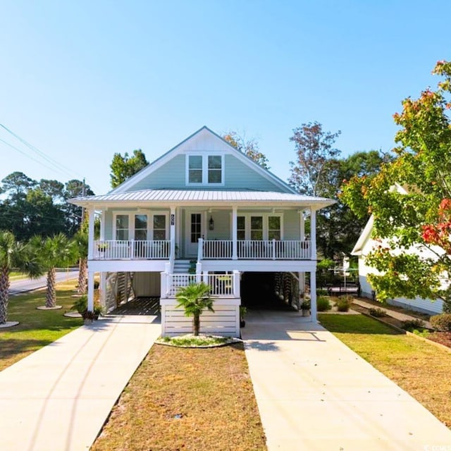 view of front of home featuring covered porch, a front lawn, and a carport