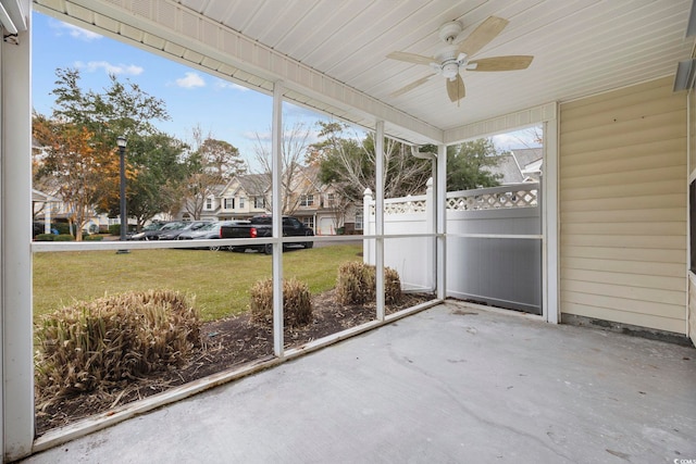 unfurnished sunroom with ceiling fan