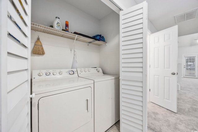 washroom with light colored carpet and separate washer and dryer