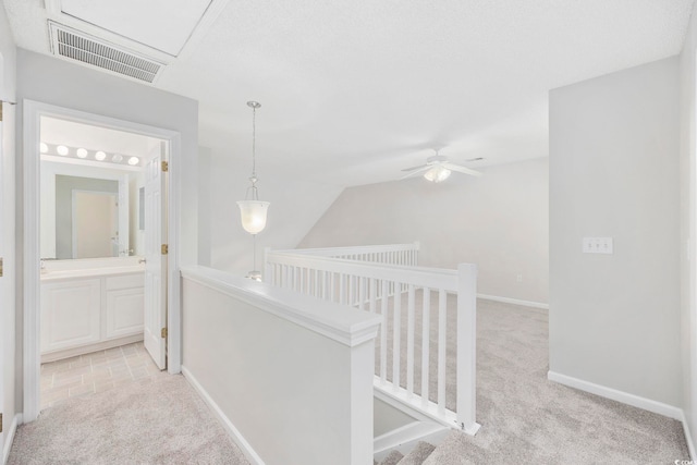 corridor featuring light colored carpet