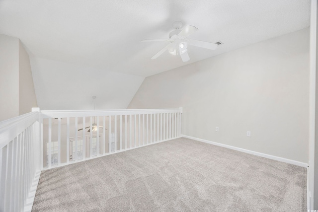 additional living space with ceiling fan, carpet, and lofted ceiling