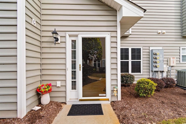 entrance to property featuring cooling unit