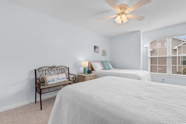 bedroom featuring carpet, a textured ceiling, and ceiling fan