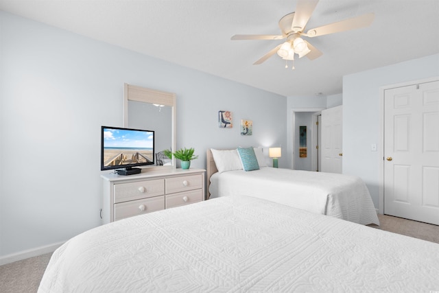 bedroom featuring light colored carpet and ceiling fan