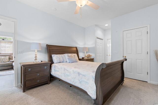 bedroom with ceiling fan, a closet, and light colored carpet