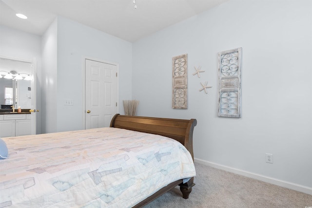 carpeted bedroom with connected bathroom