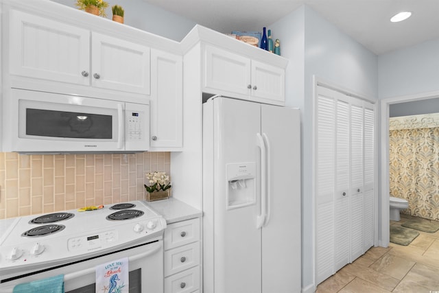 kitchen featuring white cabinets, white appliances, and backsplash