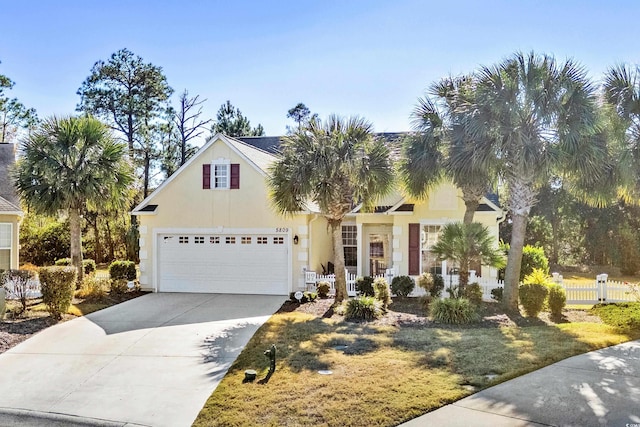 view of front of house featuring a front yard and a garage