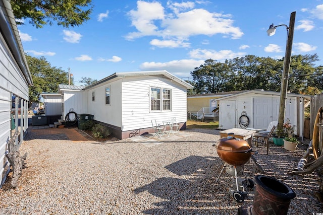 817 Wayne St, North Myrtle Beach, SC 29582 - rear view of house with a patio
