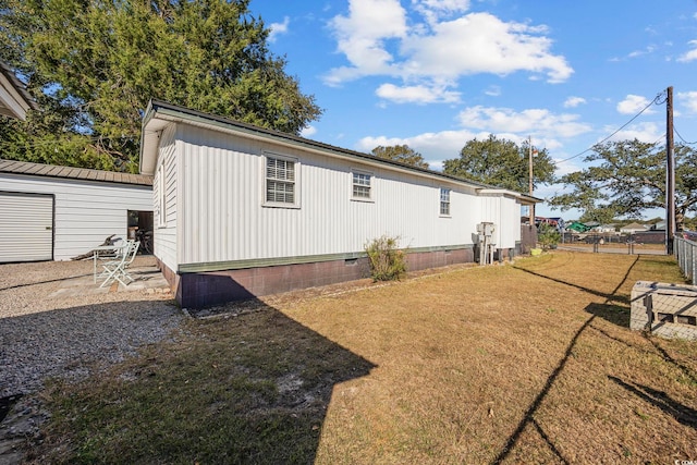 back of property featuring a lawn