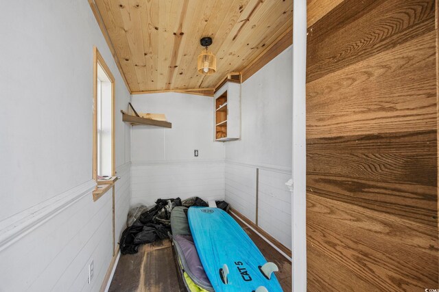 interior space featuring wood walls, wood ceiling, and wood-type flooring