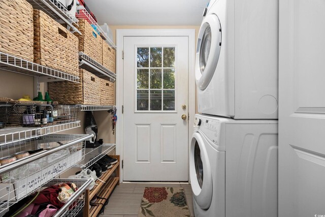 laundry area with stacked washer and dryer