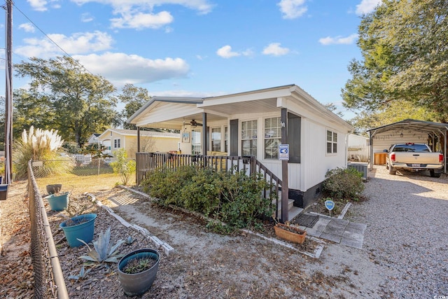 exterior space featuring a carport, a porch, and central air condition unit