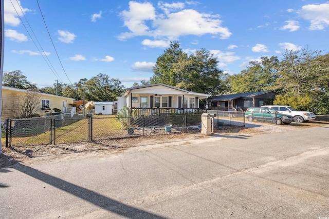 817 Wayne St, North Myrtle Beach, SC 29582 - view of front of property with covered porch, a gate, and a fenced front yard
