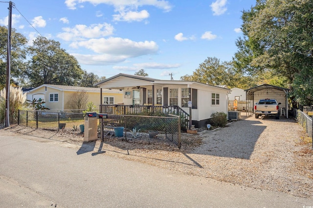 817 Wayne St, North Myrtle Beach, SC 29582 - manufactured / mobile home with a carport, a porch, central air condition unit, and driveway