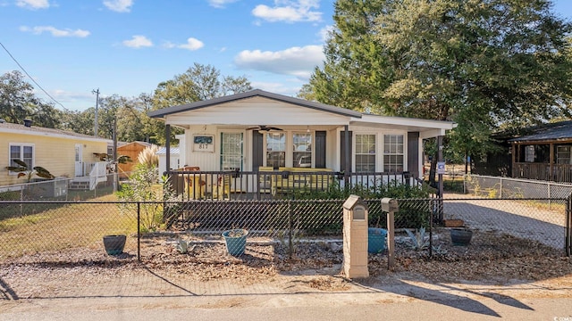 817 Wayne St, North Myrtle Beach, SC 29582 - shotgun-style home with covered porch, a fenced front yard, and ceiling fan