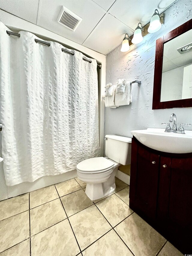 bathroom featuring visible vents, toilet, shower / tub combo with curtain, tile patterned floors, and vanity