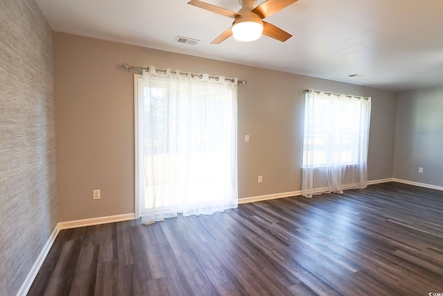 spare room with ceiling fan and dark hardwood / wood-style floors