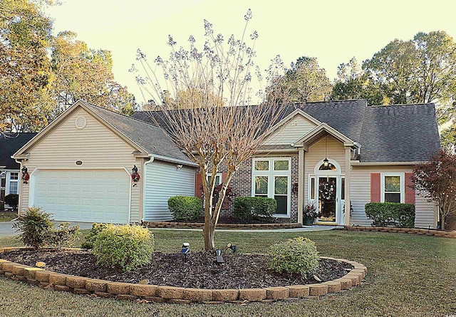 view of front facade featuring a lawn and a garage