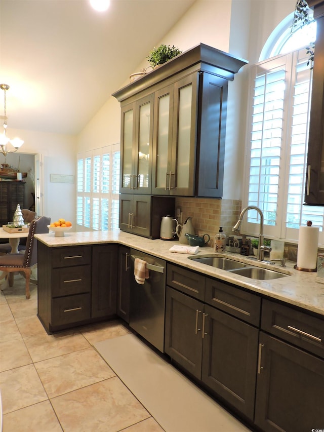 kitchen with stainless steel dishwasher, pendant lighting, sink, and vaulted ceiling