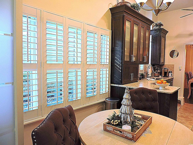 dining space featuring ceiling fan, light tile patterned flooring, and sink