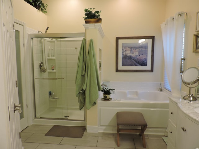 bathroom featuring tile patterned floors, vanity, and shower with separate bathtub