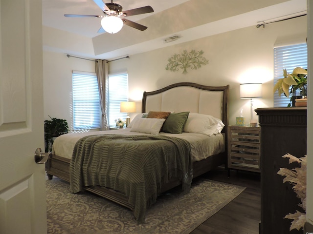 bedroom with ceiling fan and dark hardwood / wood-style flooring